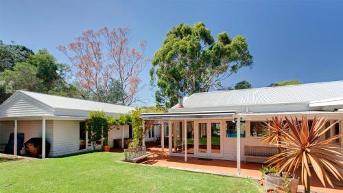 a house with a large yard in front of it at Merricks North Retreat in Merricks North