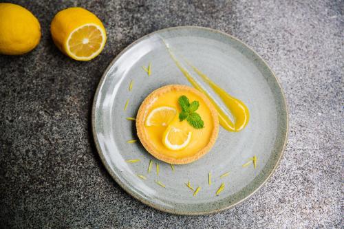a plate with an orange cut in half with a garnishment at Viroth's Villa in Siem Reap