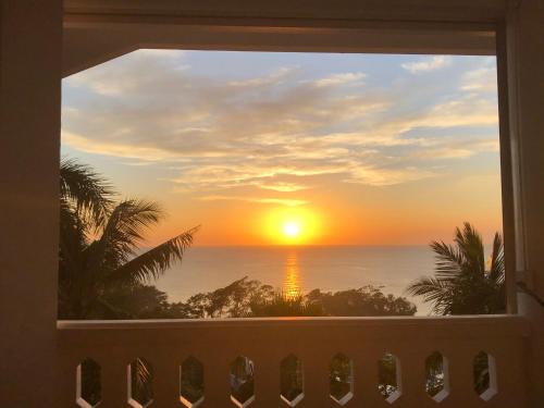 a view of a sunset from a balcony at Argonauta Boracay Apartment Suites and Villas in Boracay