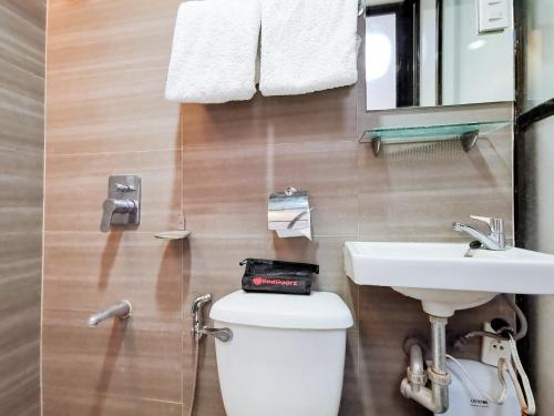 a bathroom with a white toilet and a sink at RedDoorz near Trade School Gensan in General Santos