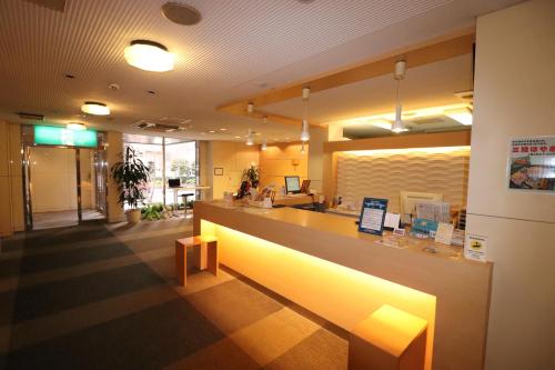 a lobby of a restaurant with a counter with lights at Hotel Green Arbor in Sendai