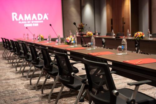 a long table with chairs and water bottles on it at Ramada Plaza by Wyndham Chao Fah Phuket in Phuket Town