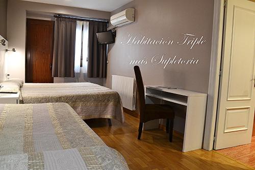 Ένα ή περισσότερα κρεβάτια σε δωμάτιο στο Hotel El Acebo