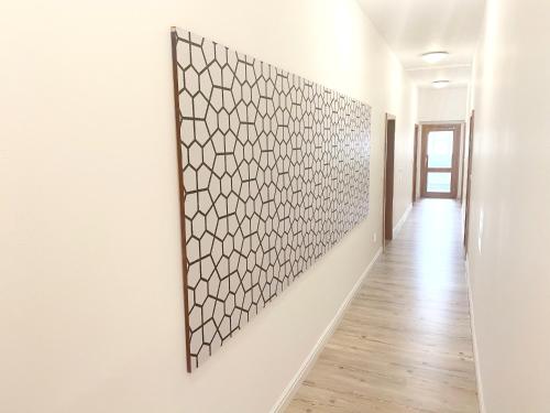 a hallway with a white wall with a picture on it at GrandLux Villa & Spa in Teplice