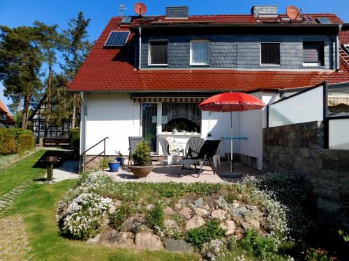 a house with a patio and an umbrella at Ferienhaus SUN Schein in Templin in Templin