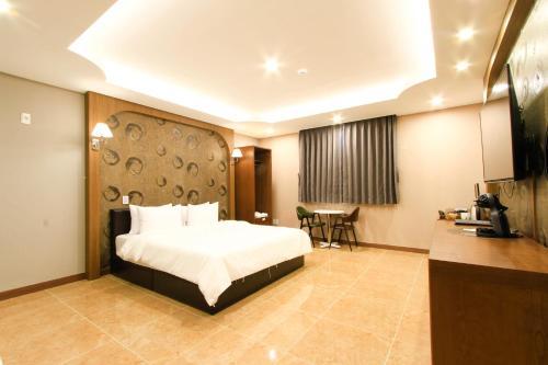a hotel room with a bed and a table at The King Hotel in Busan