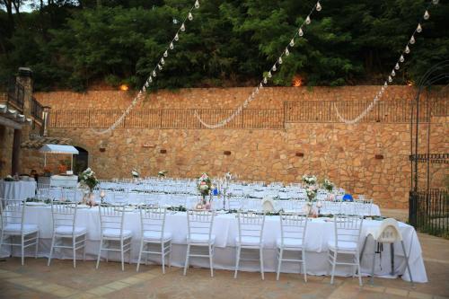 a table set up for a wedding with white tables and chairs at Leano Agriresort in Piazza Armerina