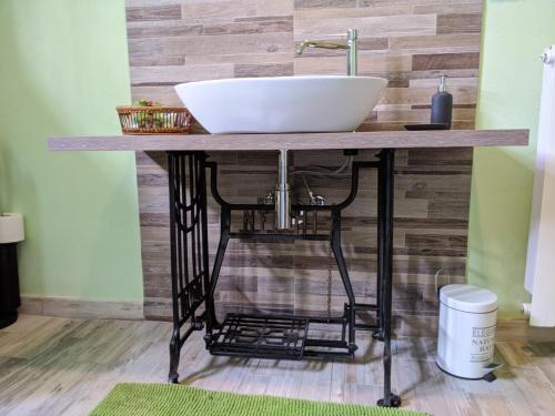 a bathroom counter with a white sink on top at Nel giardino di Oz in Fornovo di Taro
