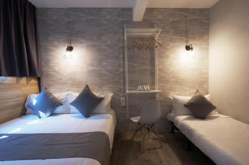 Ένα ή περισσότερα κρεβάτια σε δωμάτιο στο Q Loft Hotels at Bedok