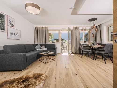 a living room with a couch and a table at Leuhaus in Mayrhofen