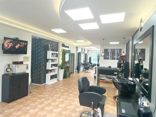 a hair salon with two chairs and a mirror at GrandLux Villa & Spa in Teplice