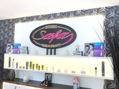 a store shelf with a sign for a salon at GrandLux Villa & Spa in Teplice