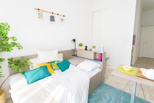 a room with a bed with pillows on it at Sweetly Alexandrin Toulouse in Toulouse