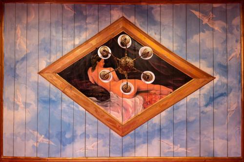 a painting of a woman on a wall at Ilion Hotel in Nafplio