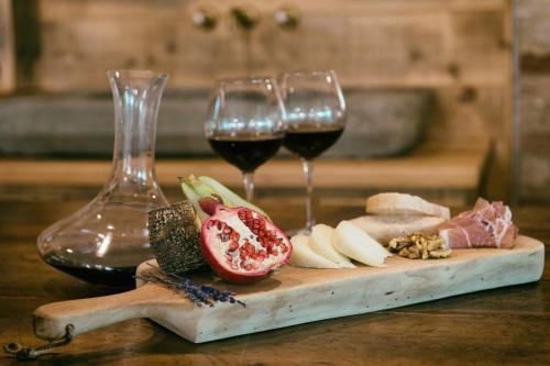 two glasses of wine and food on a cutting board at Tenuta dei Mori-Wine Relais Events in Villanova