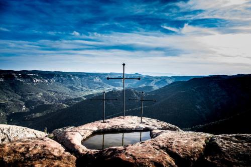 a cross on the top of a mountain at Mas de l'Arlequi in Rojals