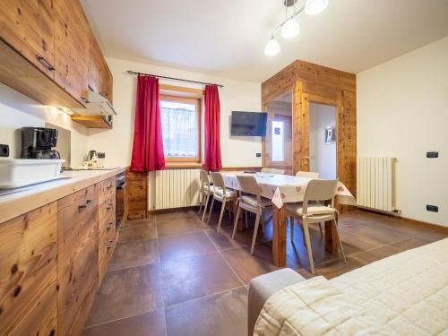a kitchen and dining room with a table and chairs at Real Wood Pemont Myholidaylivigno in Livigno