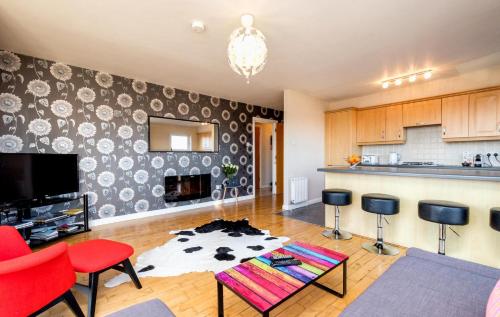 a living room filled with furniture and a tv at Ultra Urban Belfast Corporate Apartments in Belfast