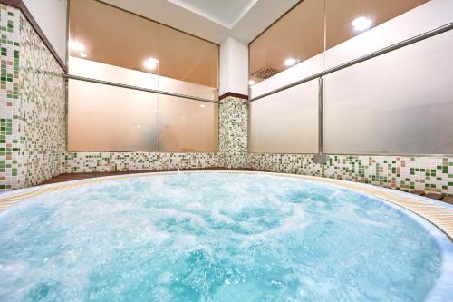 a hot tub in a room with tiles at Bordoy Continental Palma in Palma de Mallorca
