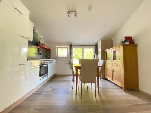 a kitchen with a table and chairs in a room at FeWo Henke in Gailingen