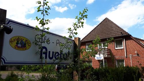 a sign in front of a brick house at Pension Auetal in Döhle