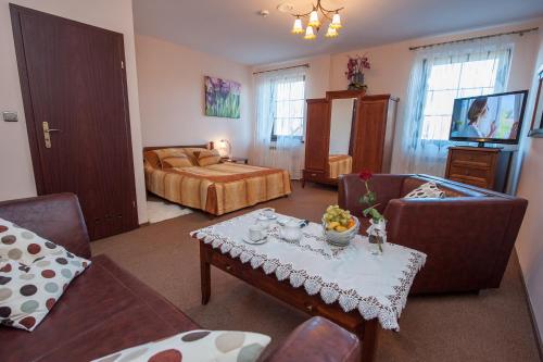 a living room with a couch and a bed and a table at Resort Jura in Kroczyce