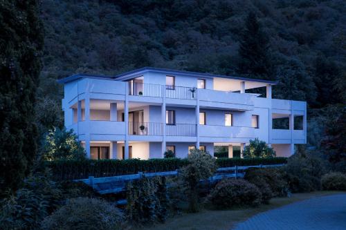 a large white building with lights on at Penthouse & Garden - luxury apartment in Postal