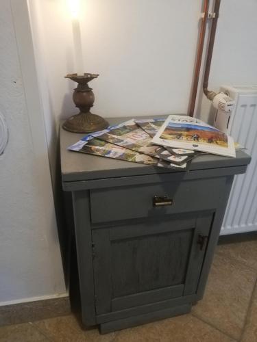 a gray table with a lamp and a book on it at Lazy Bear in Plitvička Jezera