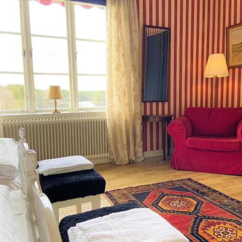 a living room with a bed and a couch at STF Jädraås Herrgård in Jädraås