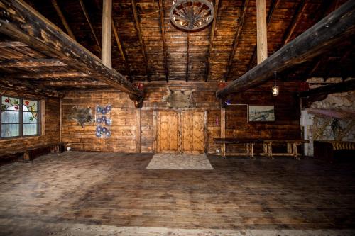 a large room with a clock on a wooden wall at Resort Jura in Kroczyce