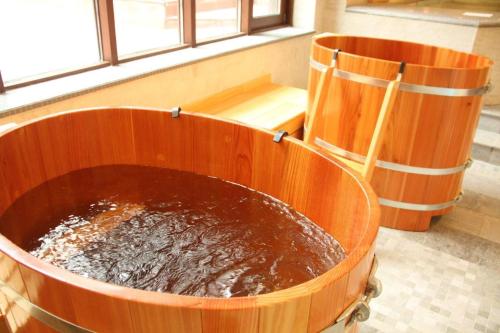 a large tub filled with water next to a window at 7 Pools SPA Boutique Hotel in Bansko