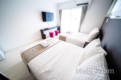 Postel nebo postele na pokoji v ubytování Roof Hanazonocho-Nishi