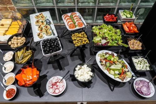 a table topped with lots of different types of food at ibis Styles Lublin Stare Miasto in Lublin