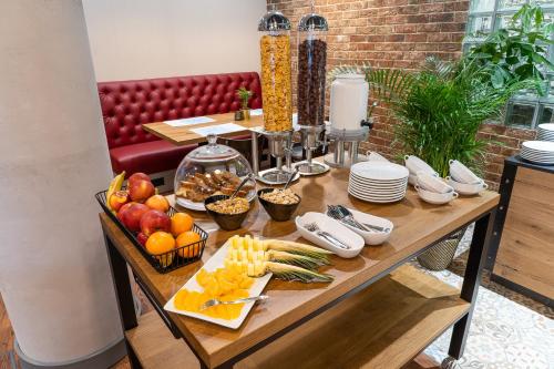 a table with fruits and vegetables on top of it at ibis Styles Lublin Stare Miasto in Lublin