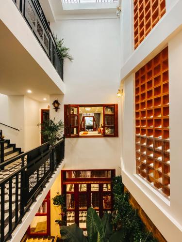 a staircase in a house with plants at Hue 1962 INN in Hue
