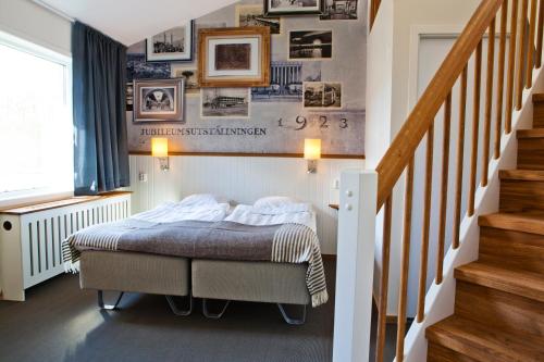 a bedroom with a bed and a staircase at Lisebergsbyns B&B in Gothenburg