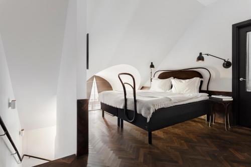 a bedroom with a white bed and white walls at Miss Clara by Nobis, Stockholm, a Member of Design Hotels™ in Stockholm