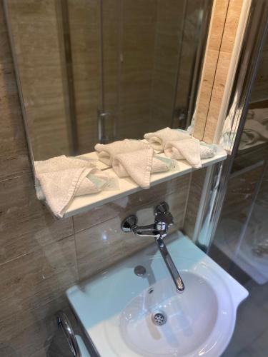 a bathroom with a sink and a mirror at Hotel Martini Zagreb Hotel and Restaurant in Sesvete
