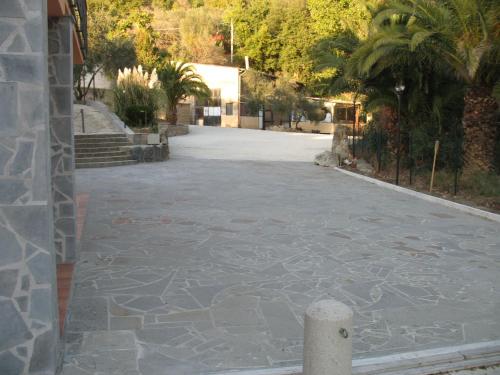 an empty street with palm trees and a building at AIR B&B PLEASANT MOMENTS in Bolsena