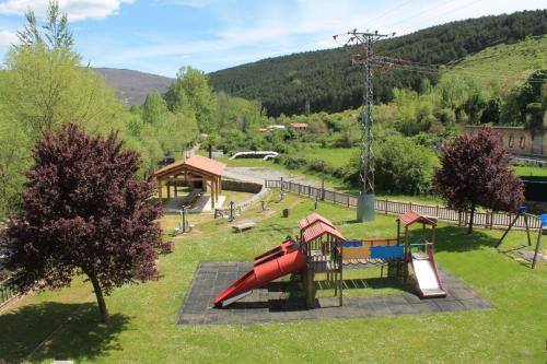 a playground with a slide in a park at Cascadas de Puente Ra in Villoslada de Cameros