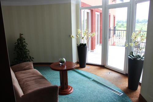 a living room with a couch and a table at Hotel Gniecki Gdansk in Przejazdowo