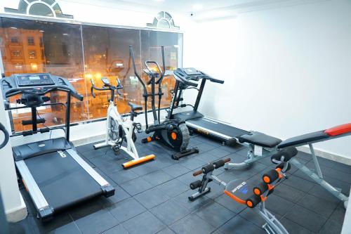 a gym with several exercise equipment in a room at Star Emirates Downtown Hotel Salalah in Salalah