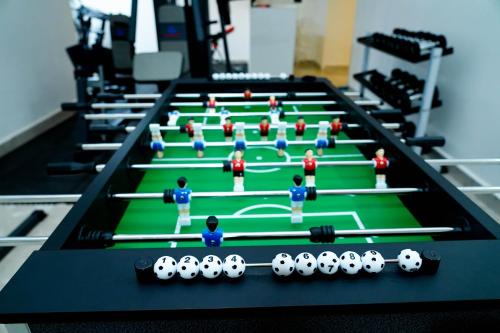 a group of people standing on a pool table at Star Emirates Downtown Hotel Salalah in Salalah