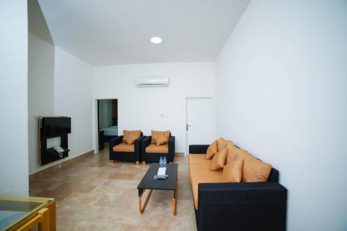 a living room with two couches and a table at Star Emirates Downtown Hotel Salalah in Salalah