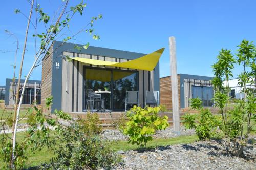 a modern house with a yellow roof at The Originals City, Ax Hotel, La Châtaigneraie in La Châtaigneraie
