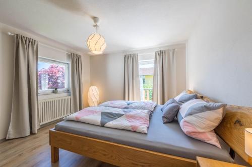a bedroom with a large bed with a window at Ferienwohnung Selina in Taching am See