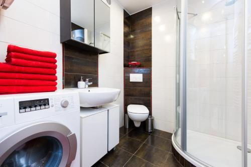 a bathroom with a washing machine and a sink at Vanilla Apartment 1 in Krakow