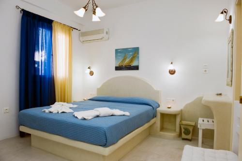 a bedroom with a bed with towels on it at Veletas Rooms in Adamantas