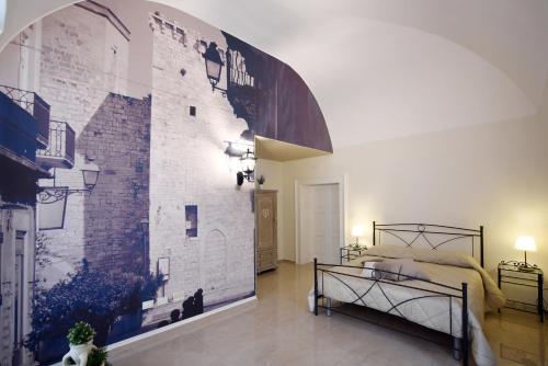 a bedroom with a wall with a brick wall at KAPSOTT B&B in Bisceglie