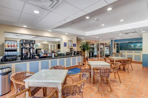 a restaurant with tables and chairs and a counter at Hutchinson Island Hotel in Fort Pierce